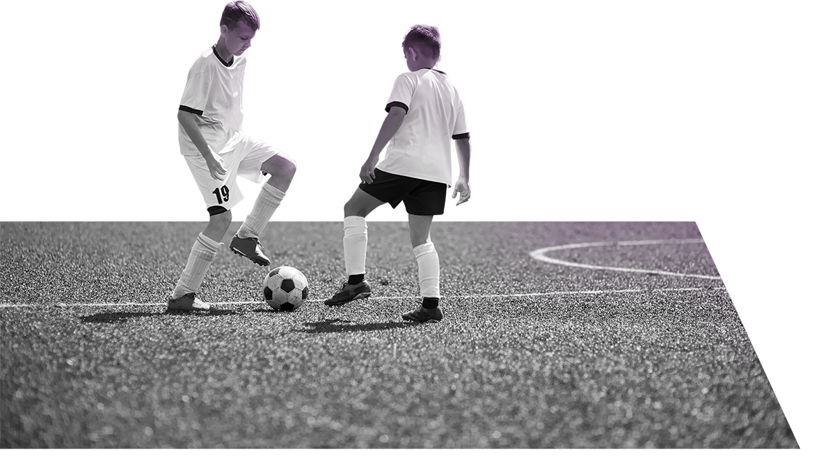 Two youth athletes playing soccer